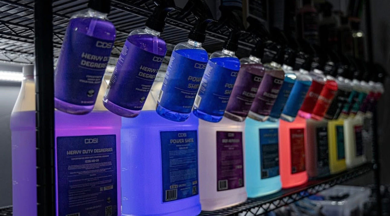 Row of CDS automotive fluids on a shelf with colorful labels.