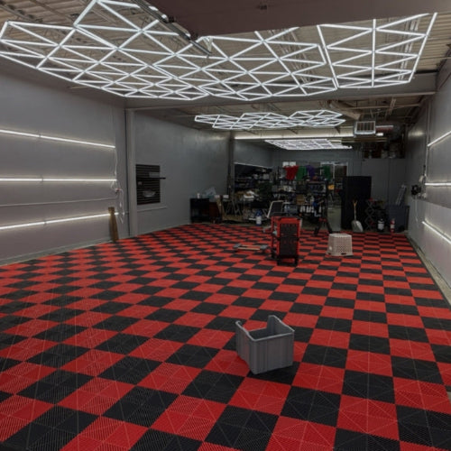Modern interior with red and black checkered floor, metallic walls, and various equipment.