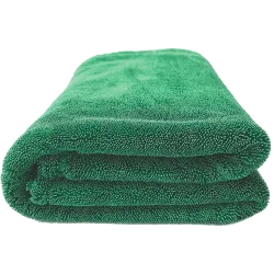 Folded green towel on a white background